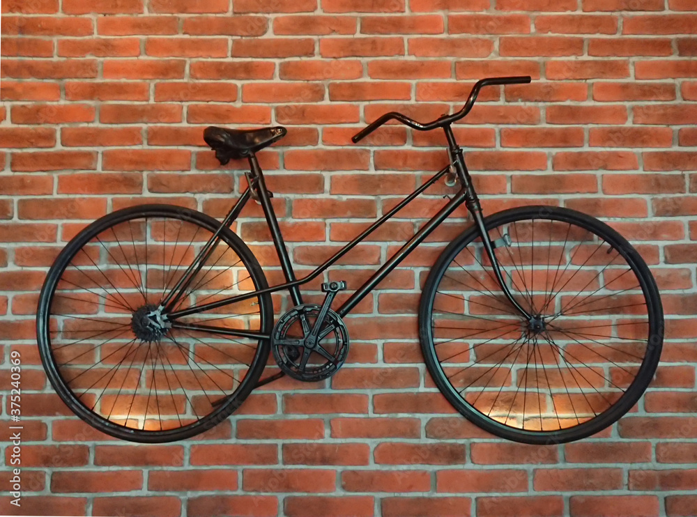 Black bike on a brick wall