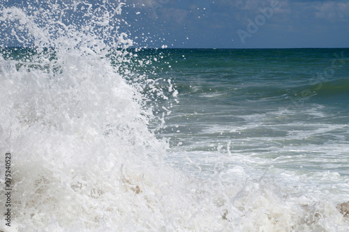 big white waves hitting the sea shore