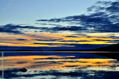 Fabulous mirror sunset. Lake Keret, Northern Karelia, Russia photo