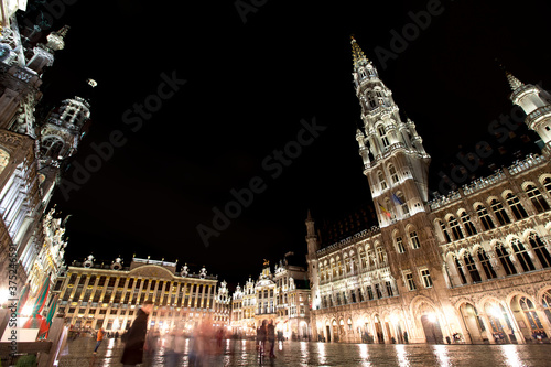 Panoramic night view of grand place of Brussels ( Belgium ) during rain. Long time exposure. The grand palace on the right. its Baroque style is part of UNESCO world heritage