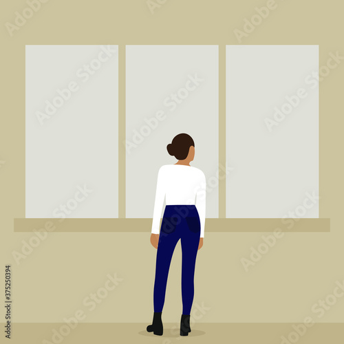 Female character stands and looks out the window