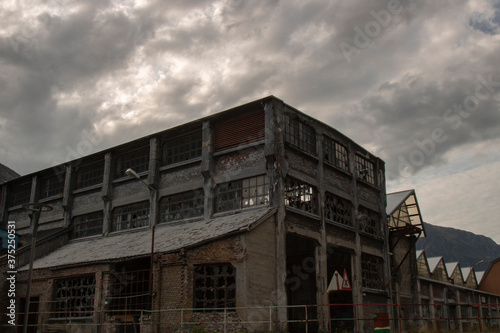 Abandoned factory under a stormy sky
