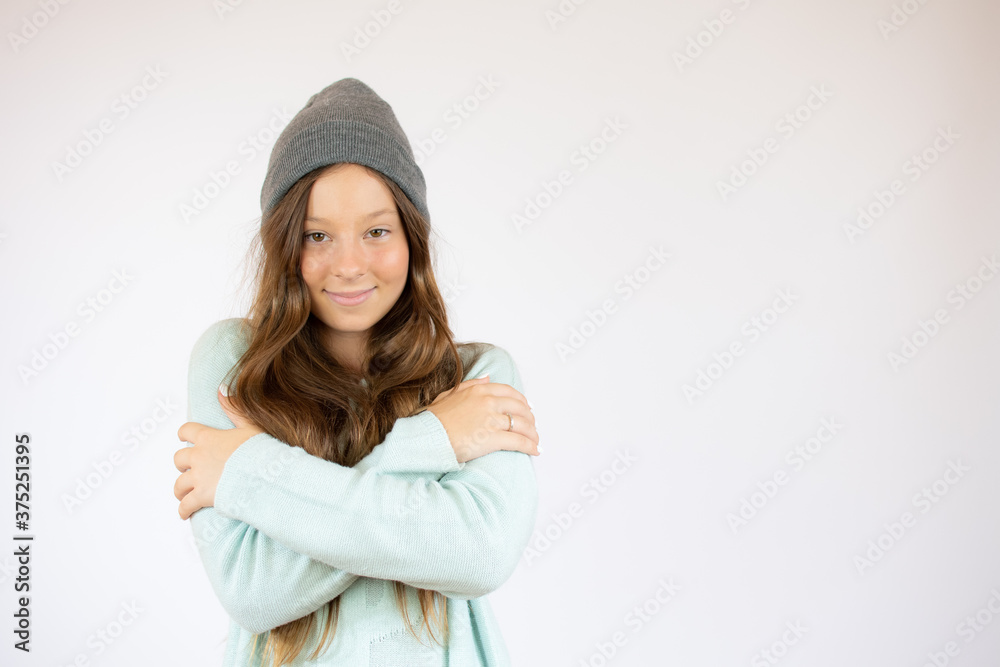 Smiling girl in winter clothes with the arms crossed Smiling girl in winter clothes with the arms crossed