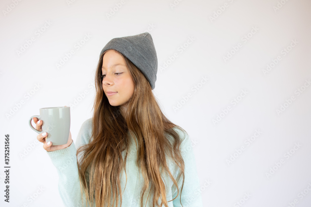 Smiling beautiful girl in winter clothes with a cup Smiling beautiful girl in winter clothes with a cup