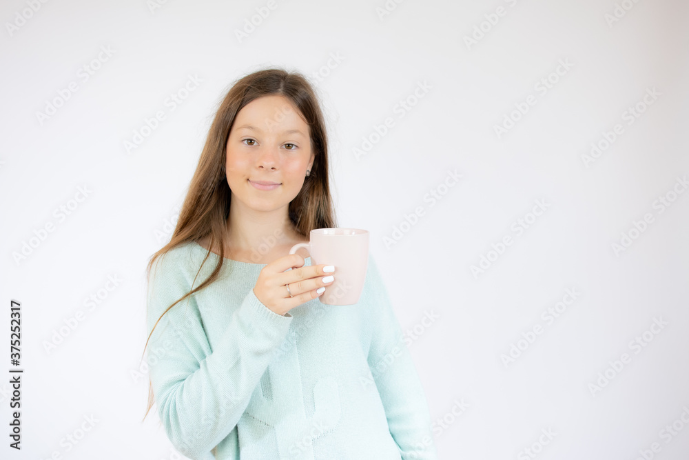 Smiling girl with a cup on white background