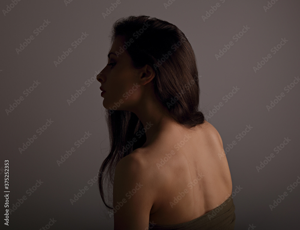 Beautiful makeup sexy woman with nude back on grey background with empty copy space. Closeup profile view portrait. Art. Beautiful makeup sexy woman with nude back on grey background with empty copy space. Closeup profile view portrait. Art.