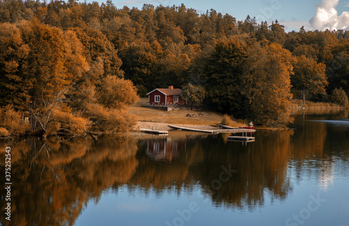 
Sweden. Small house by the lake on an autumn day
