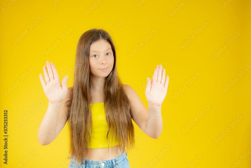 Beautiful girl with long hair making the stop gesture Beautiful girl with long hair making the stop gesture