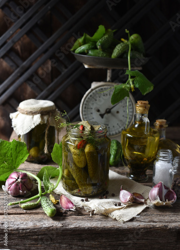Salted cucumbers. Spices and herbs for making pickles on wooden background 