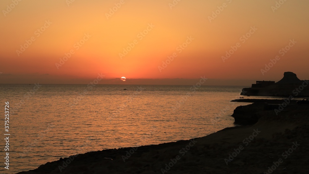 Sunrise over Xwejni Saltpans in Gozo (Island of Malta) Sunrise over Xwejni Saltpans in Gozo (Island of Malta)