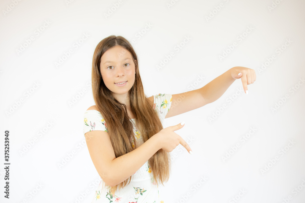 Smiling beautiful girl with long hair pointing down Smiling beautiful girl with long hair pointing down
