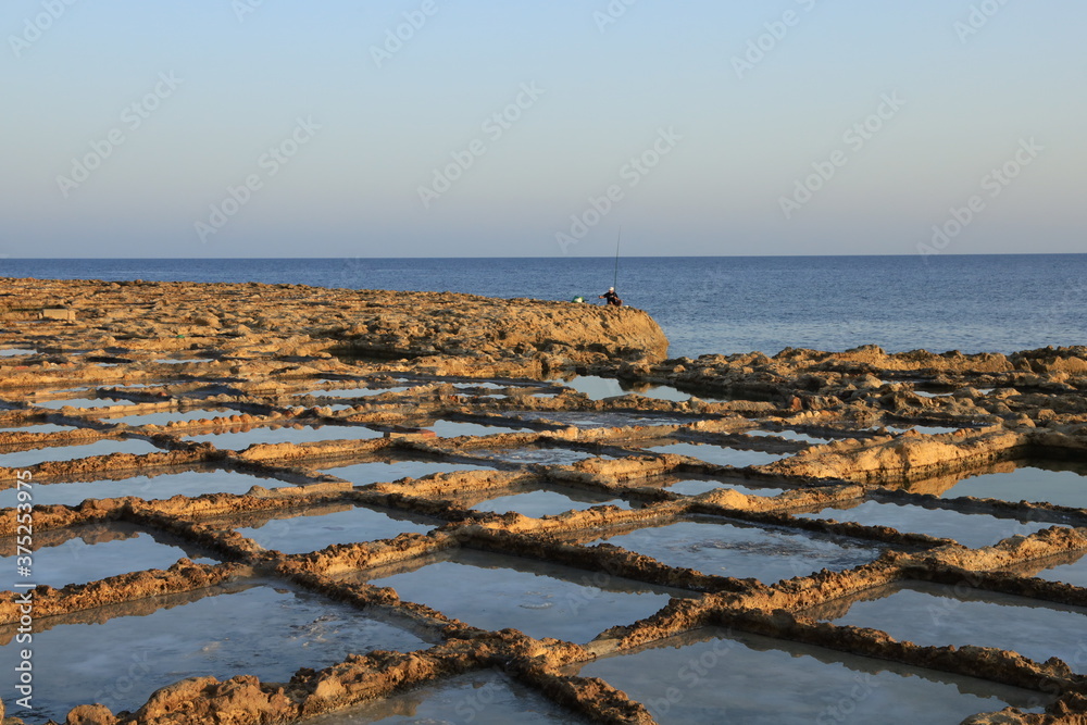 Sunrise over Xwejni Saltpans in Gozo (Island of Malta) Sunrise over Xwejni Saltpans in Gozo (Island of Malta)