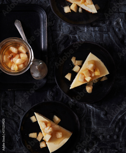 Overhead view of whiskey infused with apples and star anise on cheesecake