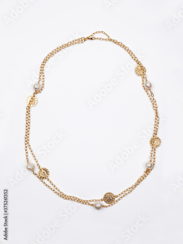 Women`s gold necklace with pearl on white background