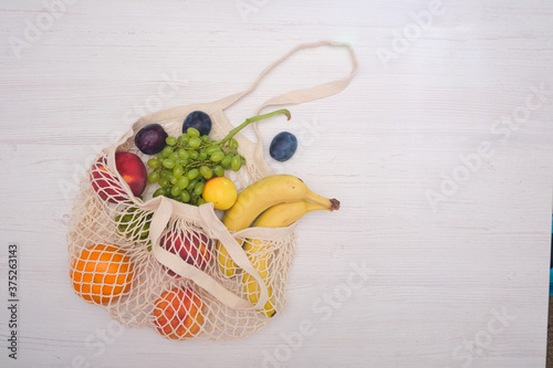 Zero waste cconcept. Package-free food shopping. Eco friendly natural bag with organic fruits and vegetables. Sustainable lifestyle concept. Plastic free items. Reuse, reduce, refuse. Top view. photo