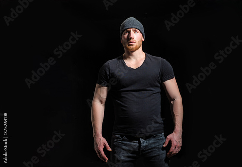 Handsome man wear black t-shirt. Studio fashion portrait.