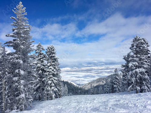 View over Carson Valley, Nevada, from Heavenly Ski Resort Lake Tahoe, with snow covered trees and clouds in the winter