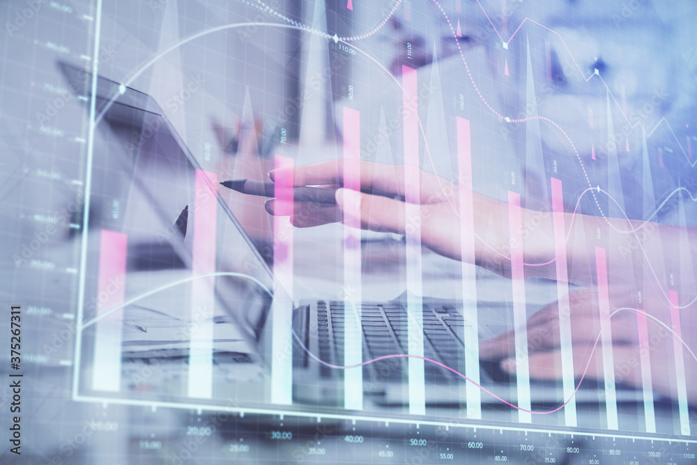 Multi exposure of woman hands typing on computer and financial graph hologram drawing. Stock market analysis concept.
