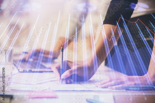 Multi exposure of woman hands typing on computer and financial chart hologram drawing. Stock market analysis concept.