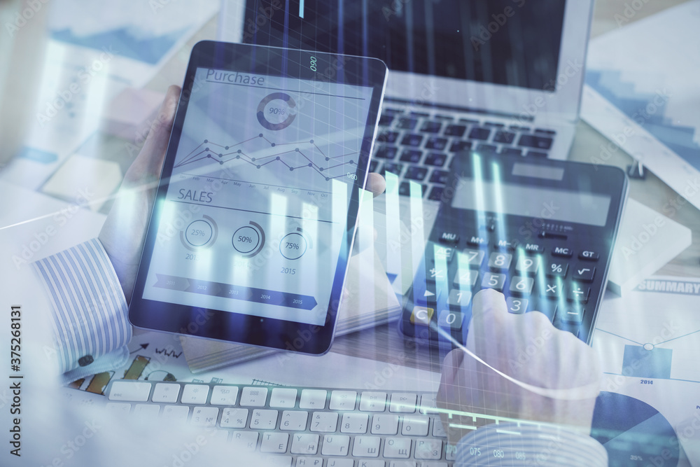 Double exposure of man's hands holding and using a digital device and forex graph drawing. Financial market concept. Double exposure of man's hands holding and using a digital device and forex graph drawing. Financial market concept.