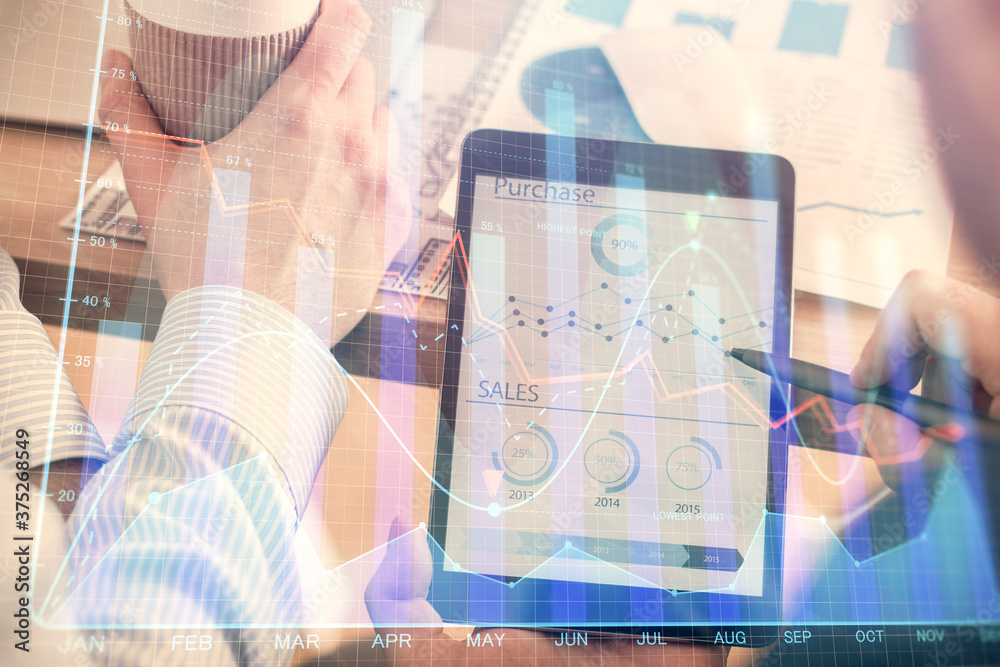 Double exposure of man's hands holding and using a phone and financial chart drawing. Market analysis concept. Double exposure of man's hands holding and using a phone and financial chart drawing. Market analysis concept.