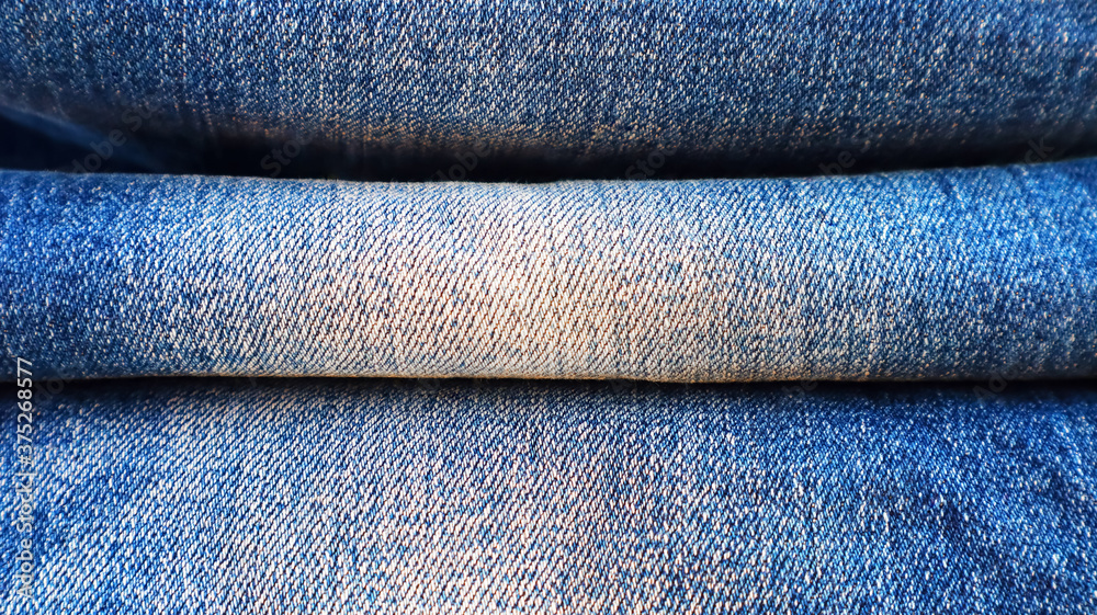 Stack of folded blue jeans close-up Stack of folded blue jeans close-up