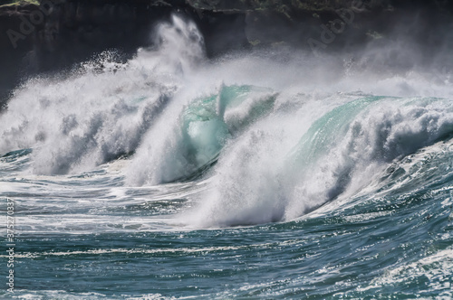 Breaking wave hitting the beach