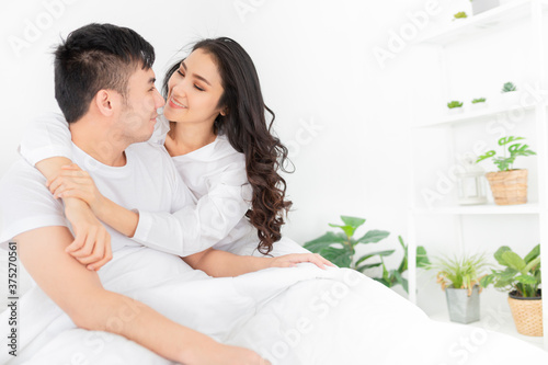 close up woman, asian lover rest on bed, they use hand hug body together, they feeling love and happy together, happiness honeymoon and valentine's day © jokekung
