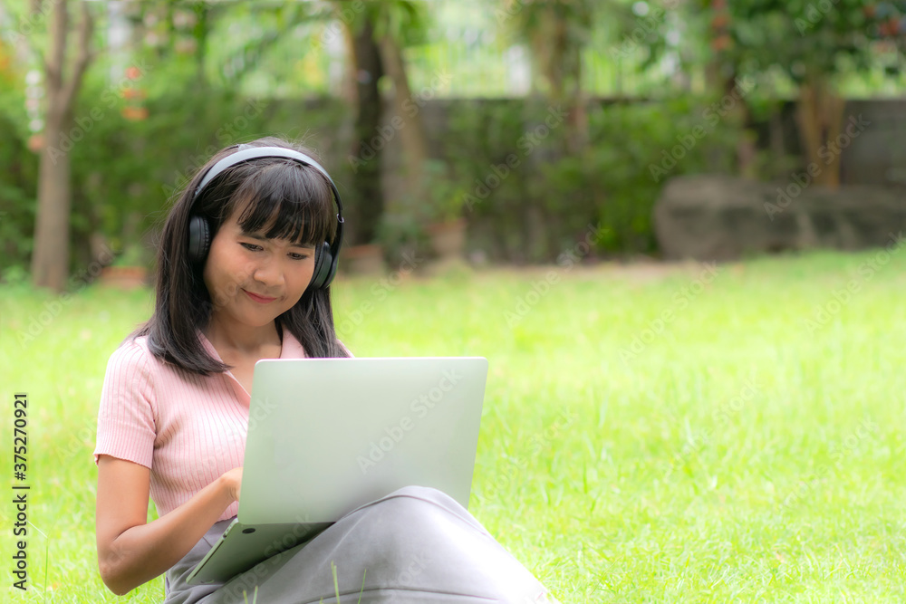 Bloger sitting use computer laptop for work and shopping online at the park in rest day. Asian woman black hair and skintan authentic her smile happy. Bloger sitting use computer laptop for work and shopping online at the park in rest day. Asian woman black hair and skintan authentic her smile happy.