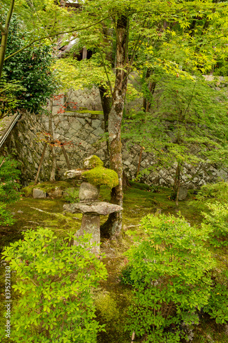 Mossy stone garden lantern in the garden of Banshu-Kiyomizu temple in Kato city, Hyogo, Japan. 