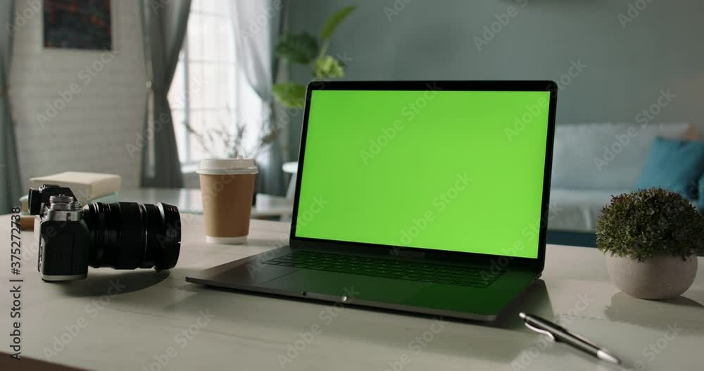 The table of distant worker at home. Modern laptop computer with chroma key green screen. Remote work, distance learning, technology concept close up 4k video template The table of distant worker at home. Modern laptop computer with chroma key green screen. Remote work, distance learning, technology concept close up 4k video template