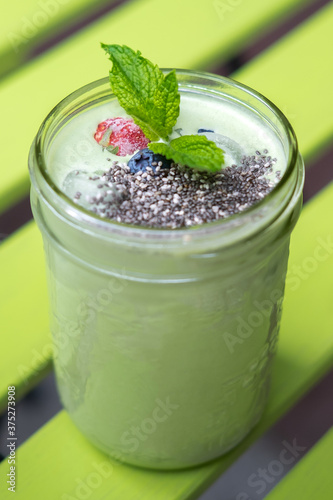 Iced Matcha Tea Smoothie with Chia Strawberry Blueberry and Mint in a Jar