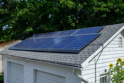 Photograph of solar panals installed on the roof of a detached two car garage. photo