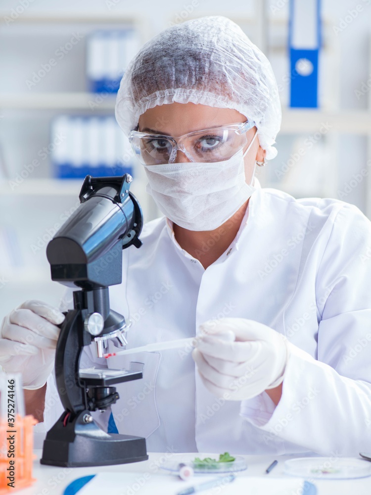 Female scientist researcher conducting an experiment in a labora Female scientist researcher conducting an experiment in a labora