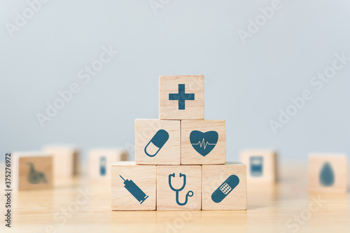 Wood block stacking with icon healthcare medical, Insurance for your health concept