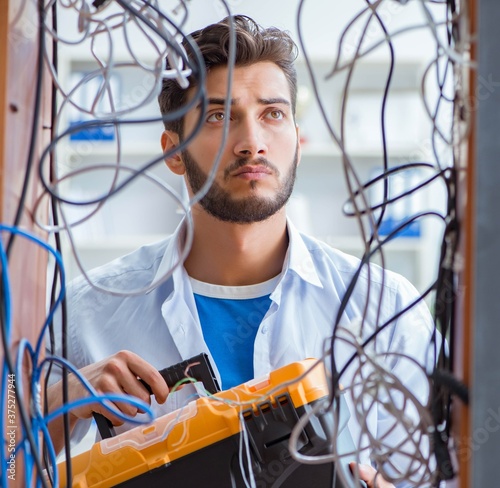 Computer repairman working on repairing network in IT workshop