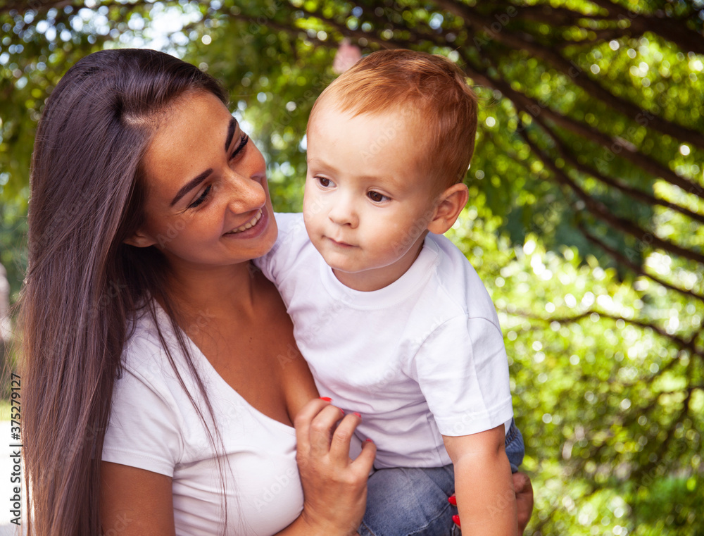 young pretty brunette mother with little cute boy walking in park happy smiling, lifestyle people concept young pretty brunette mother with little cute boy walking in park happy smiling, lifestyle people concept