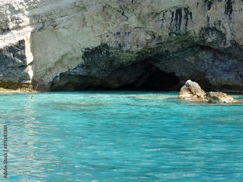 Fototapeta premium Sea cave at Porto Katsiki beach in Ionian sea in western Greece. Tourists visit western Greek island for its natural mountainous and Ionian seascape.