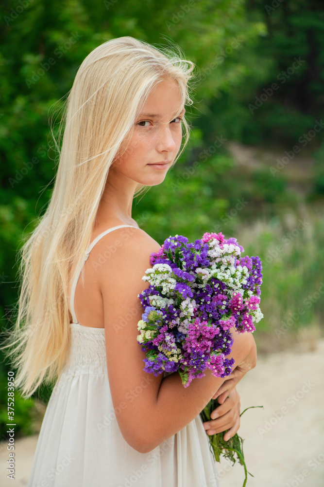 Fototapeta premium beautiful girl in a hat with flowers autumn and summer smiles