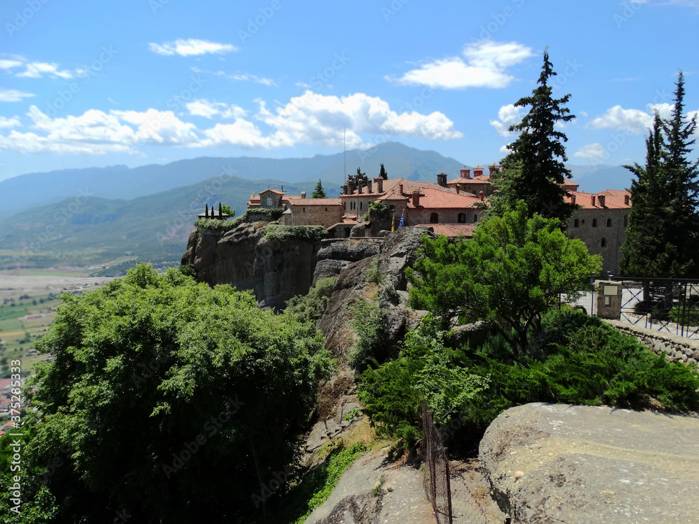 Christian monastery building on the top of hill in Meteora, Greece. Meteora is an UNESCO heritage site for monastery buildings and famous tourist attractions.