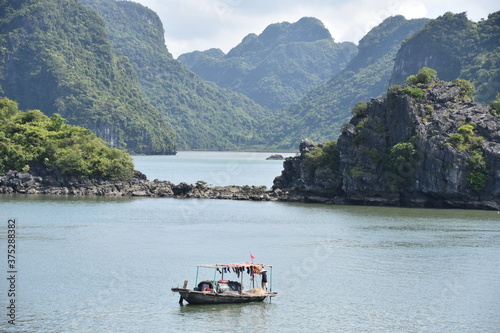 Majestic Karsts in Lan Ha Bay, Vietnam with Boat in Foreground