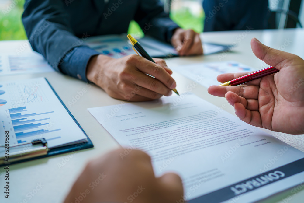 Customers sign a contract on paper letter from salesman in the office for make a purchase agreement. Customers sign a contract on paper letter from salesman in the office for make a purchase agreement.