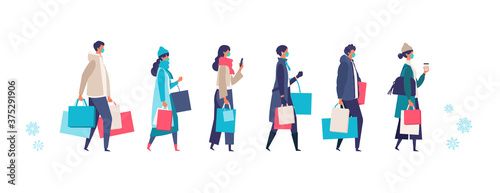 Masked people carrying shopping bags at winter. Man and woman taking part in seasonal sale at store, shop, mall on new normal lifestyle.