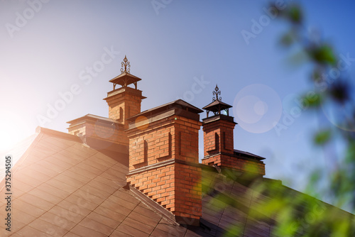 The house is of red brick with a copper roof photo