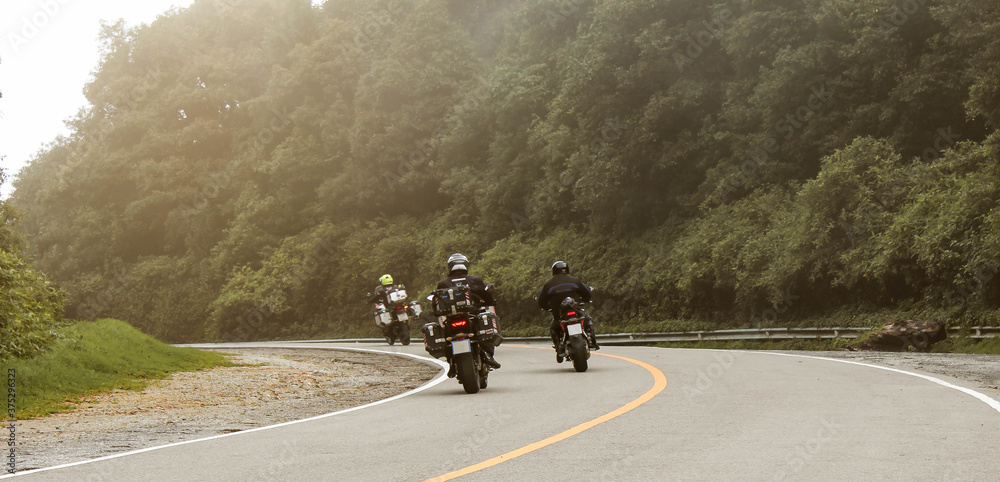Obraz premium Three bikers riding big bike motorcycle touring on Inthanon National Park, Thailand.