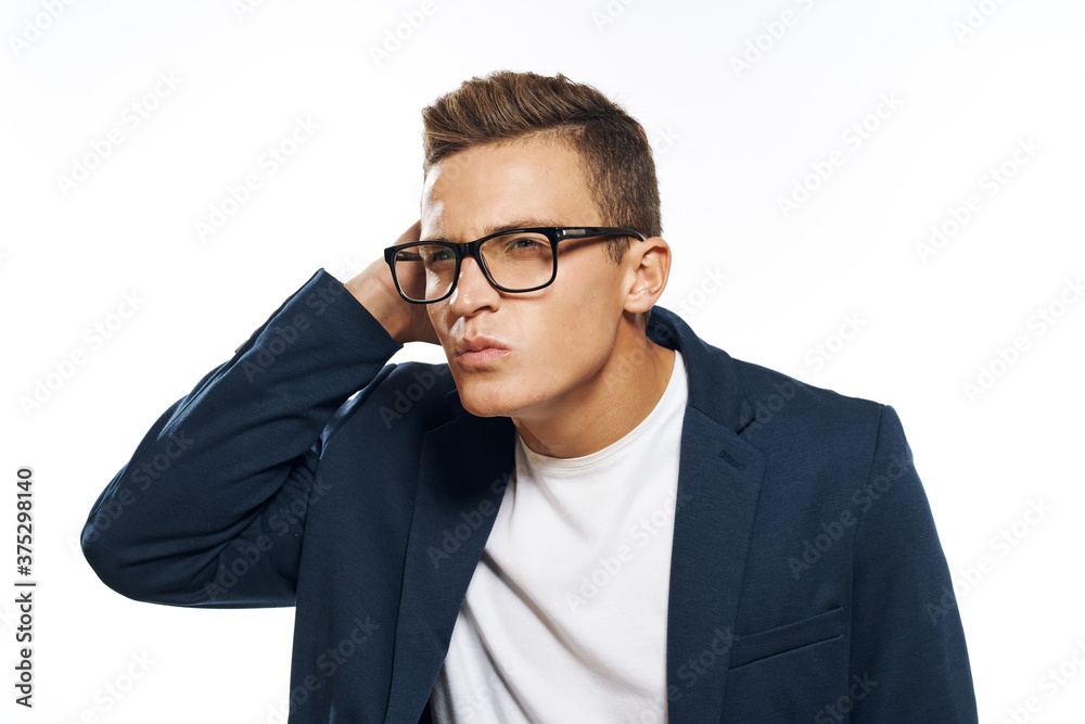 Business man in a jacket with glasses emotions official manager light background studio