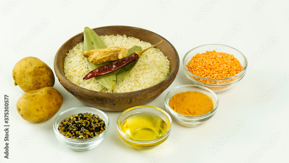 Arrangement of  Indian raw spices on colouful mini clay pots on a wooden base 