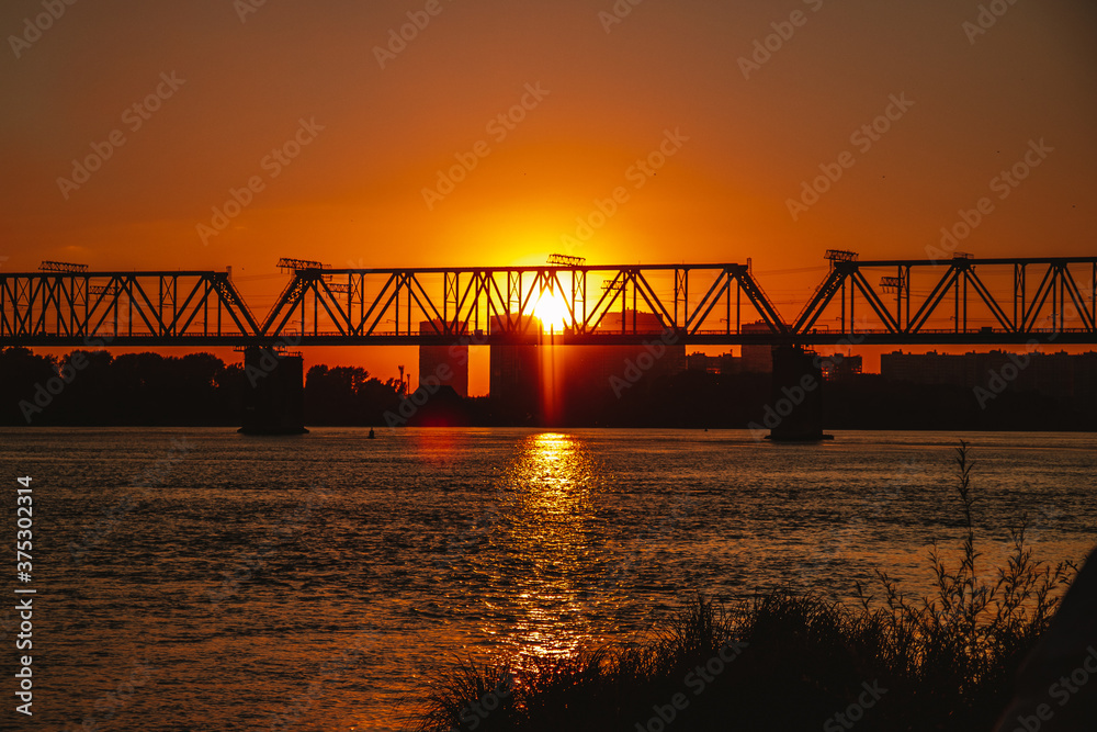 Railway bridge over the river during sunset Railway bridge over the river during sunset