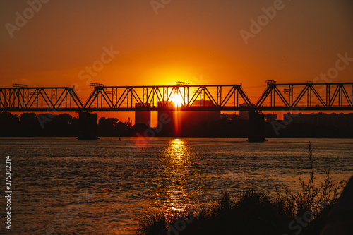  Railway bridge over the river during sunset