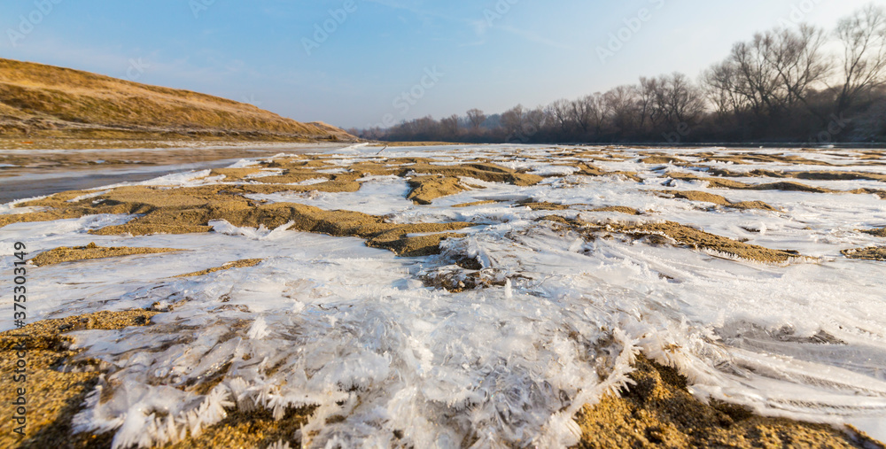 Hoarfrost and fresh powder snow in winter, on a wild, beautiful, river bank Hoarfrost and fresh powder snow in winter, on a wild, beautiful, river bank